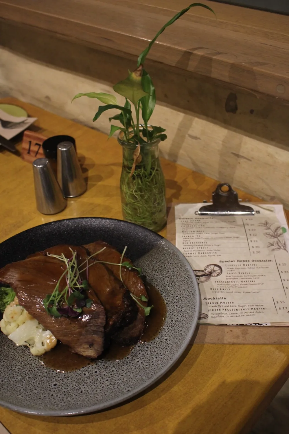 A plated roast with vegetables and gravy.