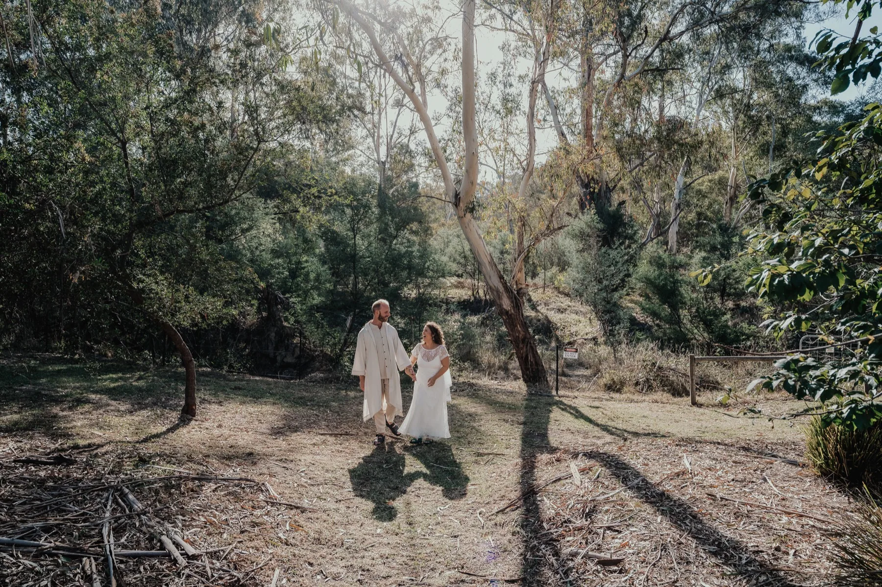Bushland clearing on the Bridges grounds, long shadows across the grass.