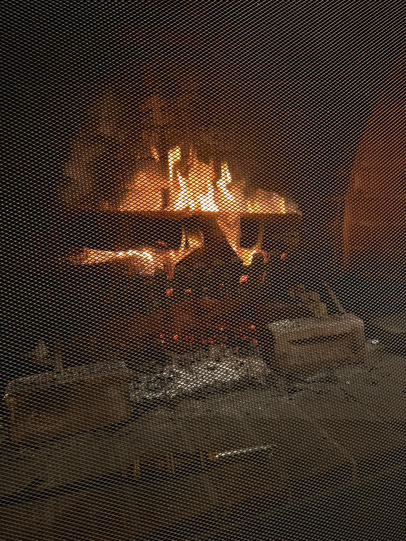A log fire burning in the open fireplace.